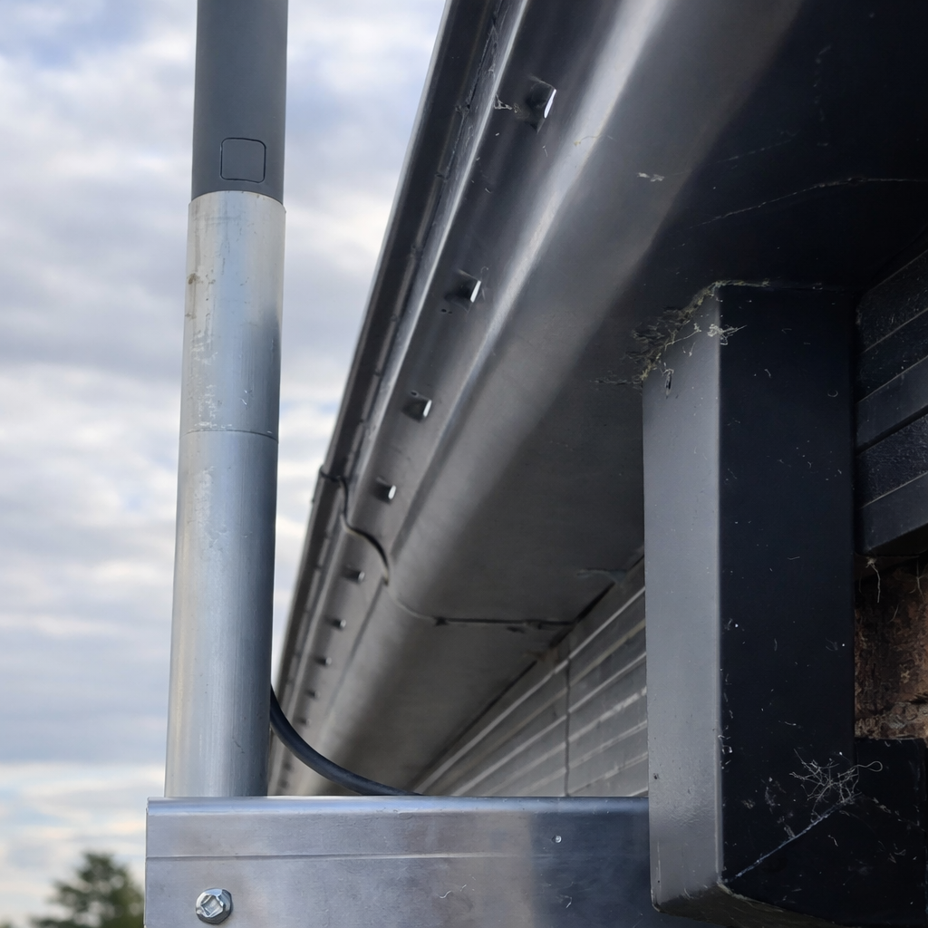 Gen 2 Starlink eave wall mount kit securing satellite dish to roof fascia and gutter on modern brick home