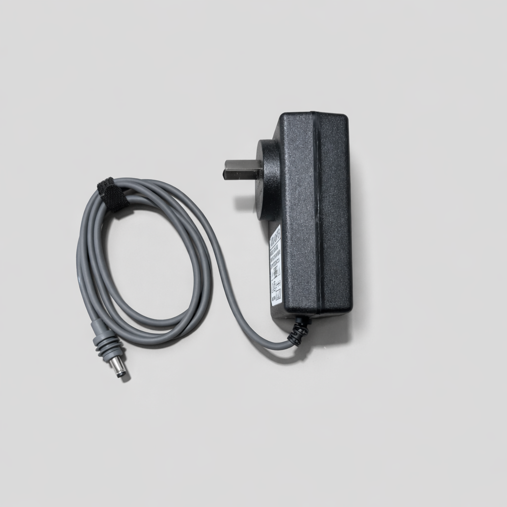 Side view of a Starlink Mini replacement AC/DC power supply showing plug depth and label, with grey cable coiled neatly on a neutral grey background