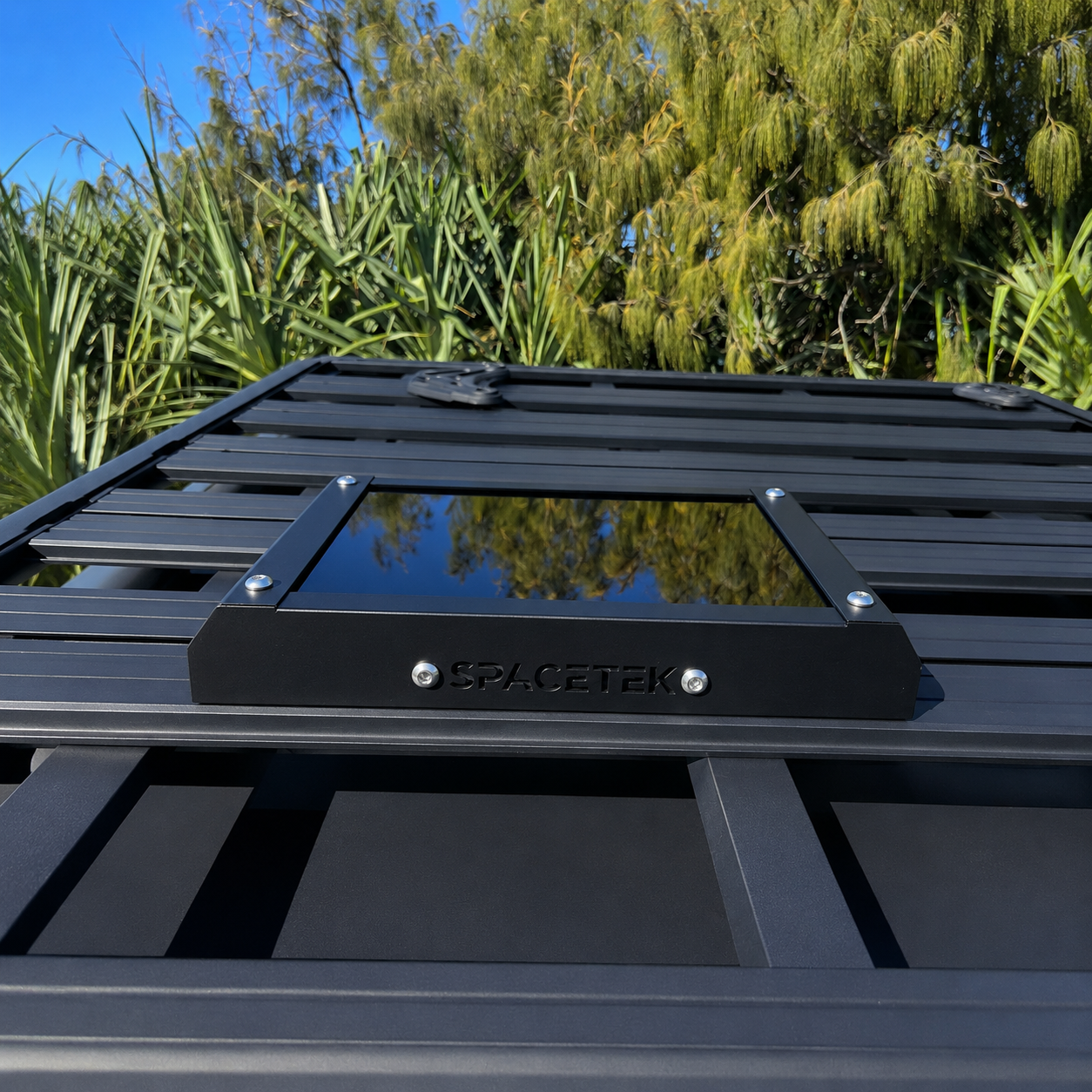 Spacetek Stealth Mount for Starlink Mini installed on a Rhino-Rack platform roof rack, featuring a low-profile black aluminium design for secure vehicle-mounted satellite internet connectivity.