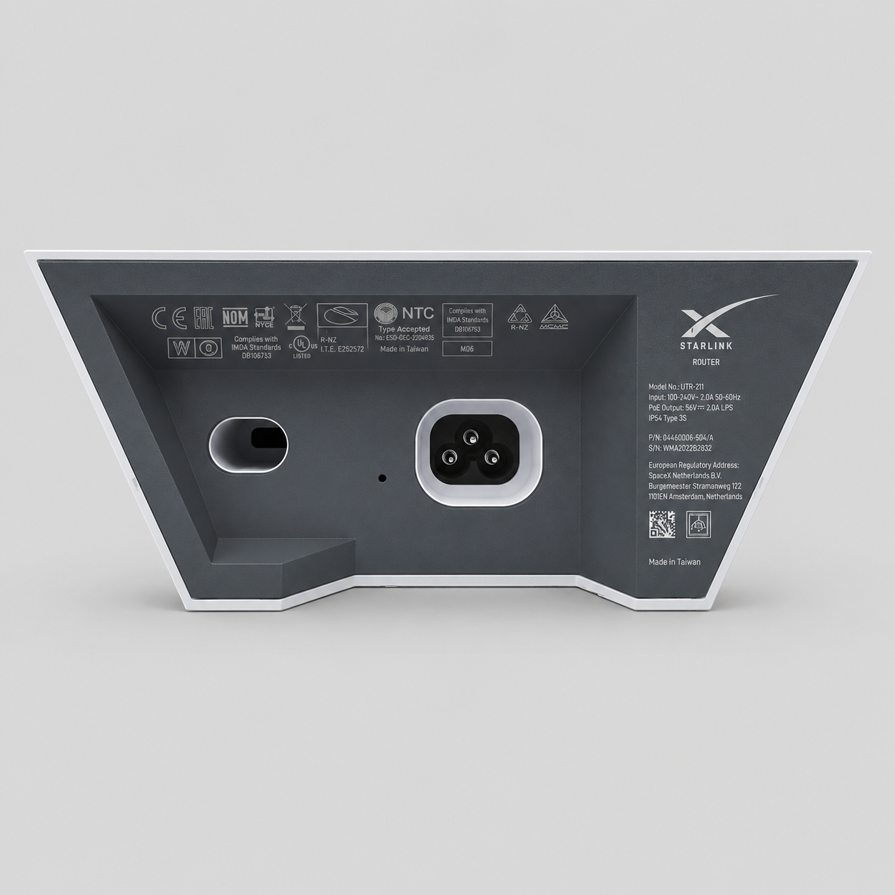 Rear view of the original Starlink Gen 2 Router UTR-211 showing the power connector, cable port and factory identification labels