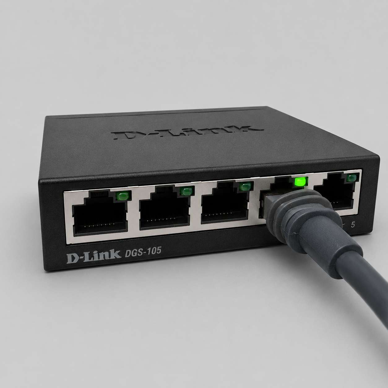 D-Link DGS-105 unmanaged 5 port gigabit Ethernet switch connected with network cable for Starlink internet expansion