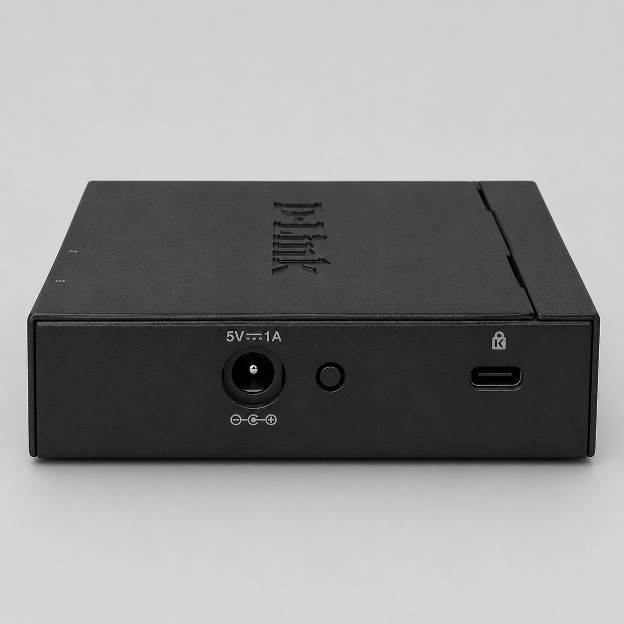 Rear view of D-Link DGS-105 unmanaged 5 port switch showing power input and security lock slot