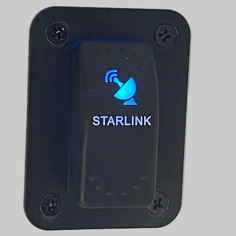 Backlit Starlink rocker switch mounted in panel for powering mobile Starlink Mini systems