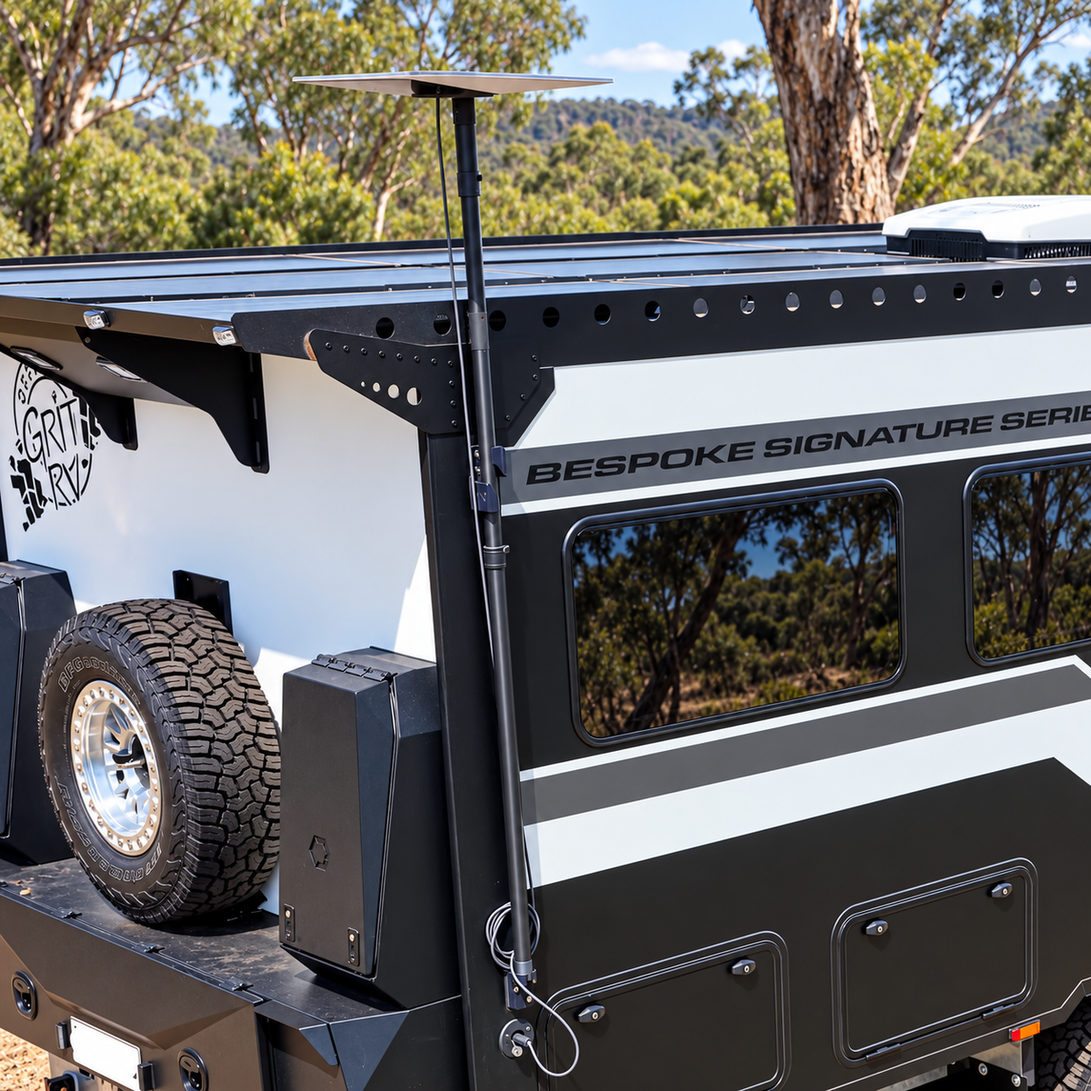 Spacetek Starlink telescopic pole mount installed on the rear corner of an off-road caravan, supporting a Starlink dish above the roof during remote Australian bush camping.