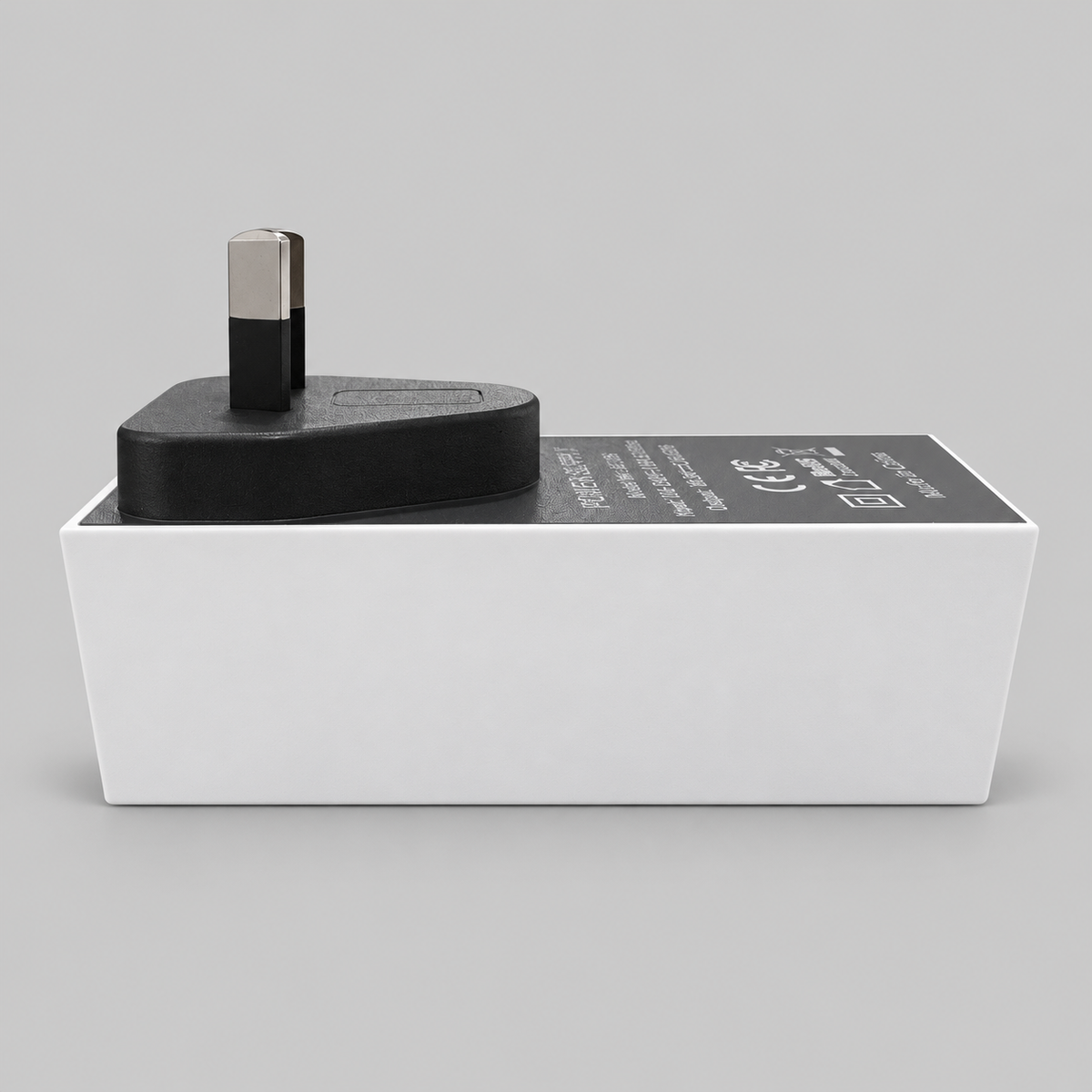Side profile of the Starlink Mini AC/DC power supply showing the white housing, black adapter body and Australian plug